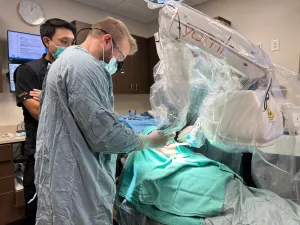 Alternate image of doctor with Yomi Implant Machine